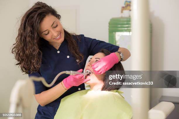 dentist examining a patient teeth - periodontal disease stock pictures, royalty-free photos & images