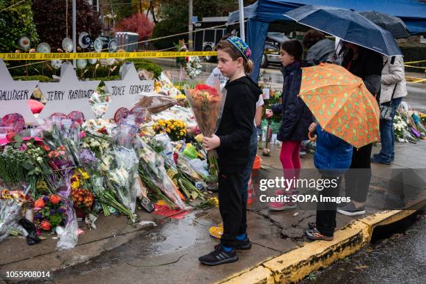 Jewish children came to pay their respects at the memorial site. Outside the Tree of Life, many come to pay their respects whether it be rain or...