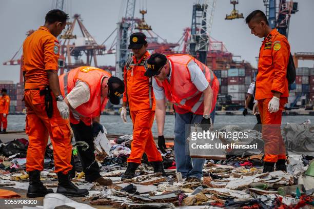 National Transportation Safety Board , Boeing and Search and Rescue personnel check debris from Lion Air flight JT 610 at the Tanjung Priok port on...