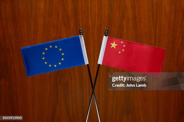 chinese and eu flags. close-up. - china european union stock pictures, royalty-free photos & images