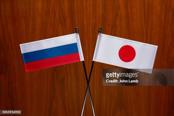 russian and japanese flags. close-up. - japan russia imagens e fotografias de stock