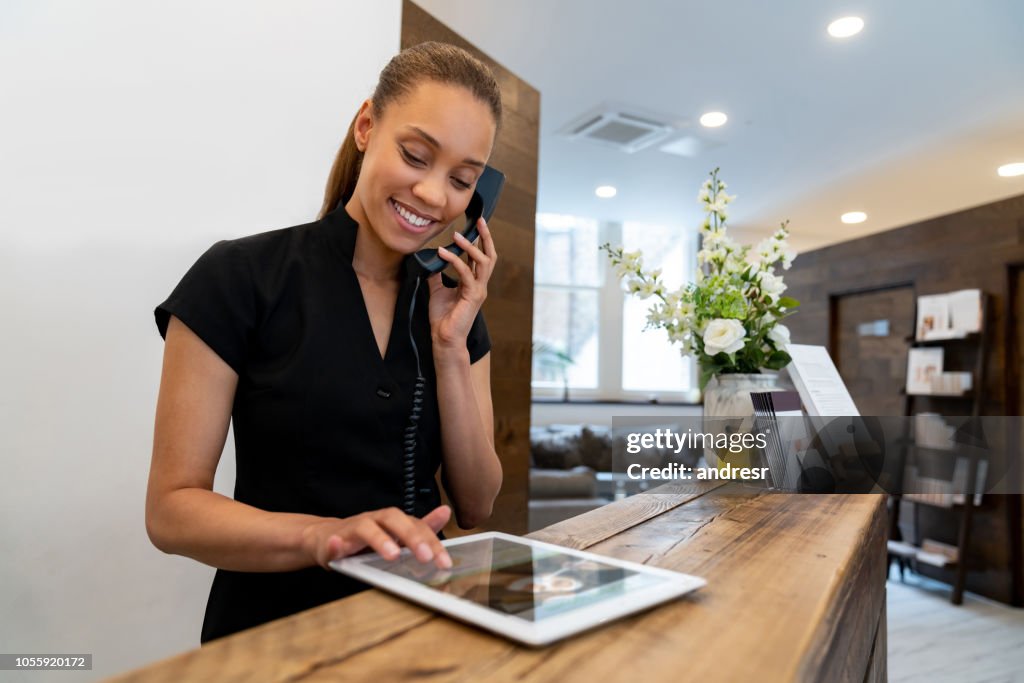 Woman working at a spa talking on the phone