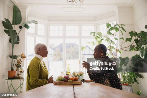 catching up over a glass of wine - only mature women stock pictures, royalty-free photos & images