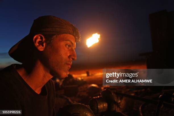 Syrian man works on October 31, 2018 at a primitive oil facility in the town of Zardana in the countryside of the northwestern Syrian Idlib province...