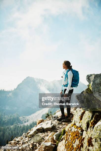 young woman enjoying view from outlook during hike in mountains - self exploration stock pictures, royalty-free photos & images