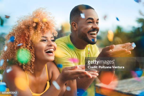 couple celebrating with confetti - fiesta stock pictures, royalty-free photos & images