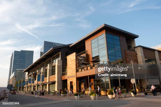 people walking on sidewalk at legacy west development in plano - west texas stock pictures, royalty-free photos & images