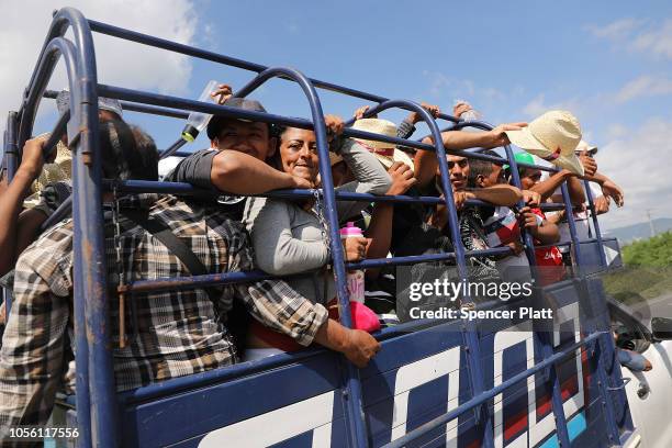 Members of the Central American caravan cram into the back of a truck as they head out for their next destination on November 01, 2018 in Juchitan,...