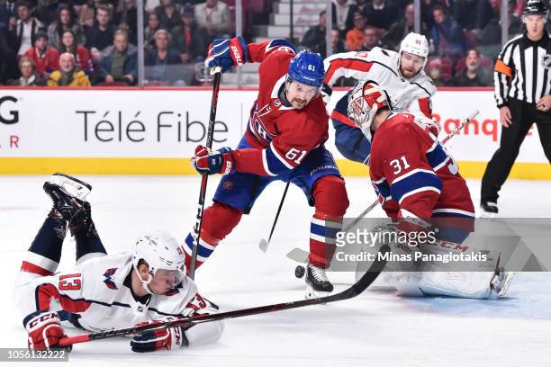 Xavier Ouellet of the Montreal Canadiens tries to pick up a rebound left by goaltender Carey Price near Jakub Vrana of the Washington Capitals during...