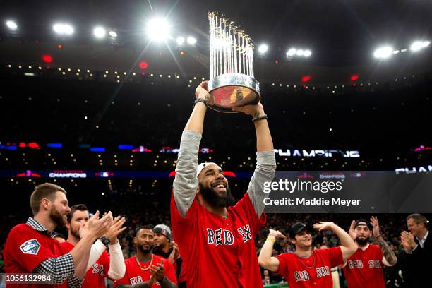 David Price of the Boston Red Sox celebrates with The Commissioner's Trophy during the first quarter of the game between the Boston Celtics and the...