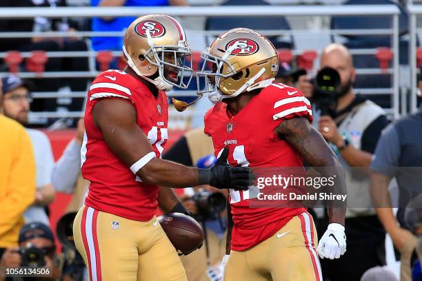 Pierre Garcon of the San Francisco 49ers celebrates with Marquise Goodwin after a 24-yard touchdown against the Oakland Raiders during their NFL game...