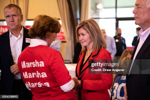 Sen. Tom Tillis looks on as U.S. Rep. Marsha Blackburn , Republican candidate for U.S. Senate, talks with supporters during a get-out-the-vote rally...