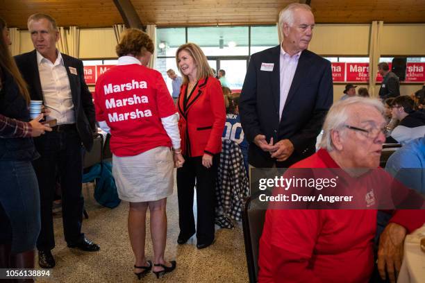 Sen. Tom Tillis looks on as U.S. Rep. Marsha Blackburn , Republican candidate for U.S. Senate, talks with supporters during a get-out-the-vote rally...