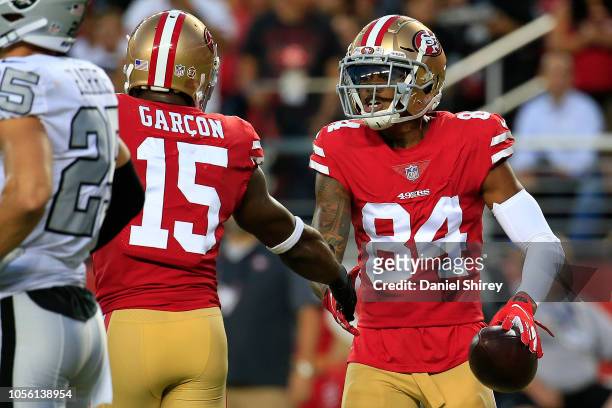 Kendrick Bourne of the San Francisco 49ers celebrates with Pierre Garcon after a four-yard touchdown against the Oakland Raiders during their NFL...