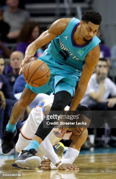 Russell Westbrook of the Oklahoma City Thunder goes after the ball against Jeremy Lamb of the Charlotte Hornets during their game at Spectrum Center...