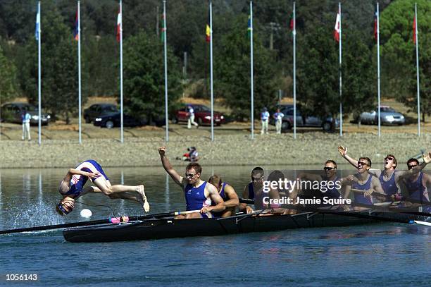 The British team celebrate winning the gold medal in the Men's Eight as cox Rowley Douglas dives in to the lake during the Sydney 2000 Olympic Games...