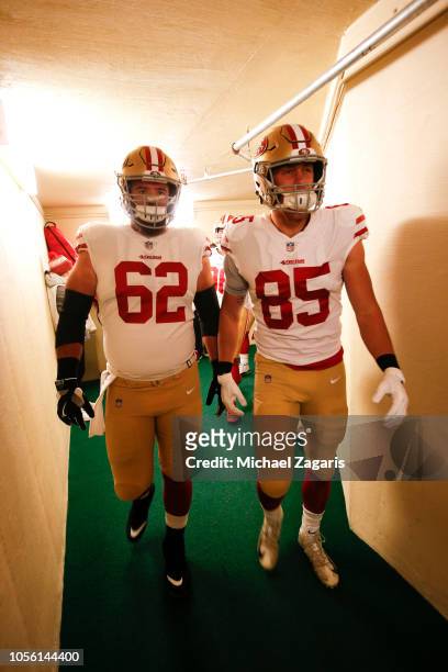 Erik Magnuson and George Kittle of the San Francisco 49ers head to the field prior to the game against the Green Bay Packers at Lambeau Field on...