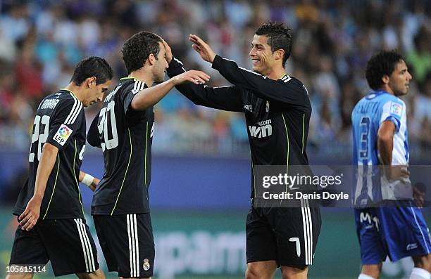 Cristiano Ronaldo of Real Madrid celebrates with Gonzalo Higuain after Higuain scored Real's first goal during the La Liga match between Malaga and...