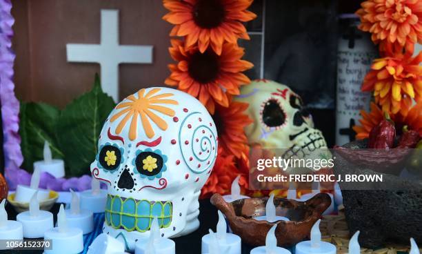 Skulls and candles on an altar display in downtown Los Angeles, California on November 1, 2018 at Day of the Dead celebration.