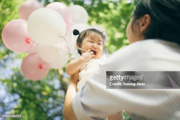 happy baby girl celebrating a birthday - korean baby girl stock-fotos und bilder