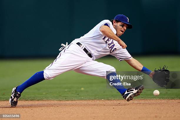 Ian Kinsler of the Texas Rangers fields a ground ball hit by Lance Berkman of the New York Yankees in Game Two of the ALCS during the 2010 MLB...