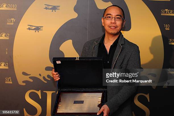 Apichatpong Weerasethakul poses on the red carept with his Jose Luis Guarner Critic Award for his latest movie 'Uncle Boonmee Who Can Recall His Past...