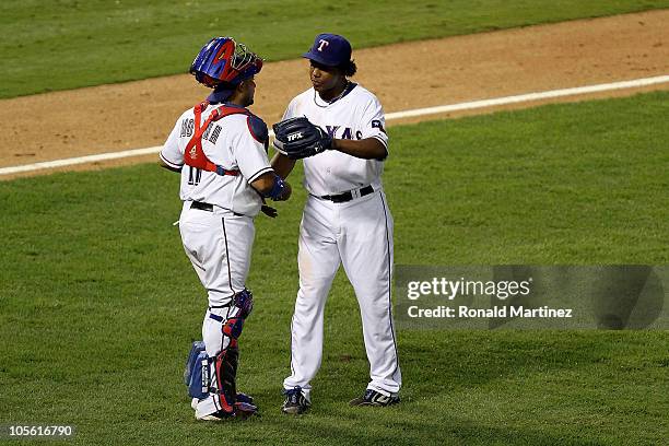 Bengie Molina and Neftali Feliz of the Texas Rangers celebrate after they won 7-2 against the New York Yankees in Game Two of the ALCS during the...