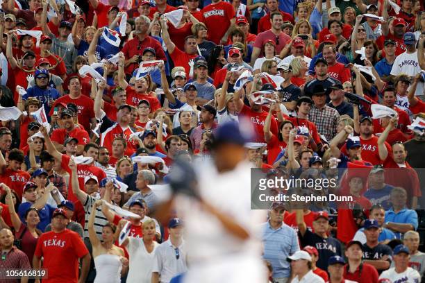 Fans cheer as Neftali Feliz of the Texas Rangers pitches against the New York Yankees in Game Two of the ALCS during the 2010 MLB Playoffs at Rangers...