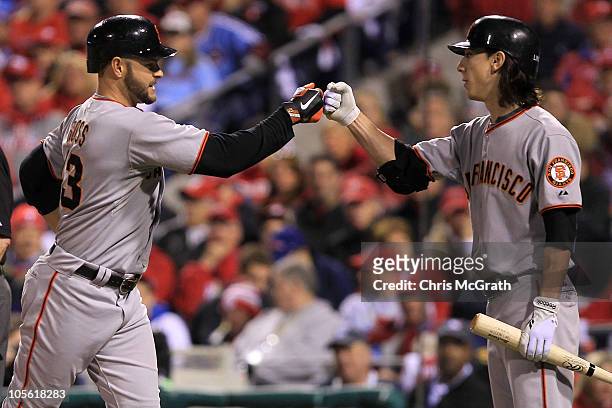 Cody Ross of the San Francisco Giants is greeted at home by pitcher Tim Lincecum after Ross hit a fifth inning home run against the Philadelphia...