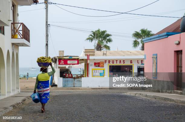 Woman seens carrying bananas at the city center. Cape Verde, is a nation on a volcanic archipelago off the northwest coast of Africa.