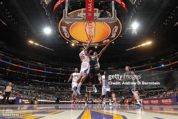 Miles of the Utah Jazz rises for a layup against Rasual Butler of the Los Angeles Clippers at Staples Center on October 16, 2010 in Los Angeles,...