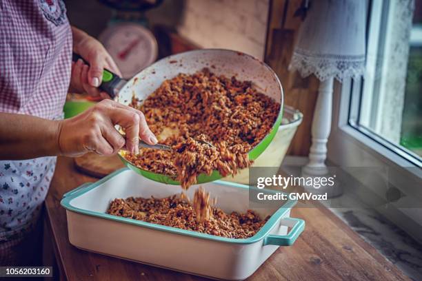 preparing traditional shepard`s pie in domestic kitchen - cooked meat stock pictures, royalty-free photos & images