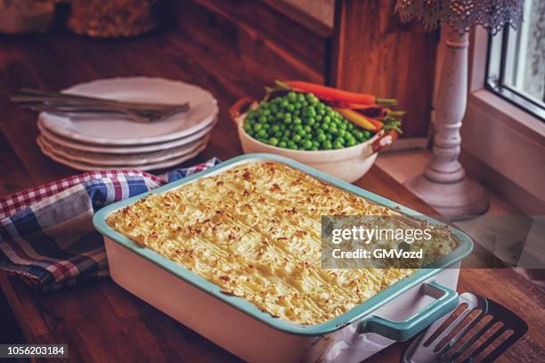 preparing traditional shepard`s pie in domestic kitchen - meat pie stock pictures, royalty-free photos & images