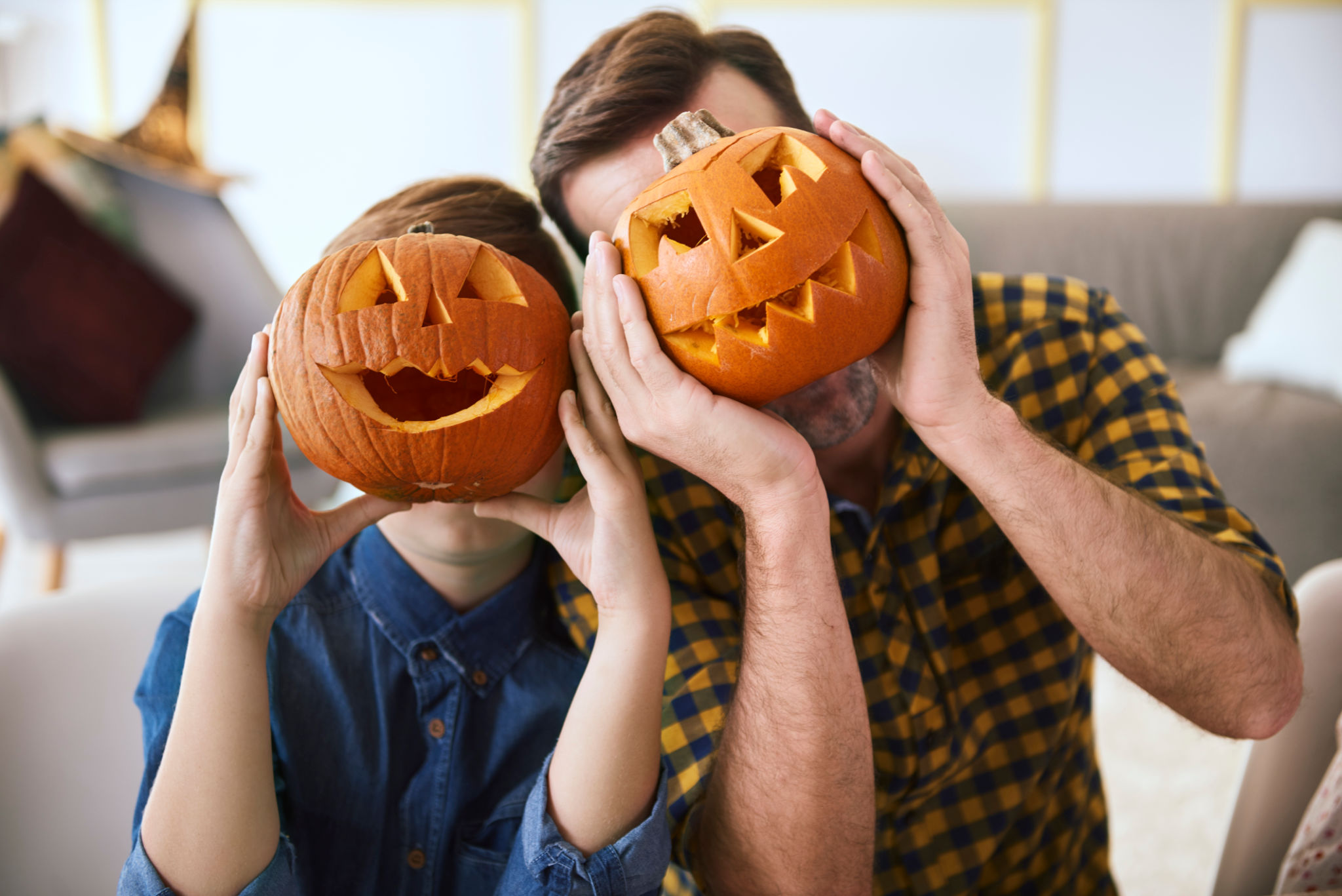 Father and boy with scary Halloween pumpkin Father and boy with scary Halloween pumpkin