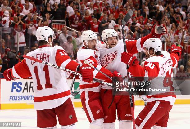 Niklas Kronwall of the Detroit Red Wings celebrates with teammates Daniel Cleary, Nicklas Lidstrom and Henrik Zetterberg after Kronwall scored the...
