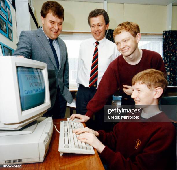 Pupils John Dunhill, seated, and Matthew Begg, both aged 15, demonstrate the new computer to Enron deputy power station manager Phill Stokes, left...