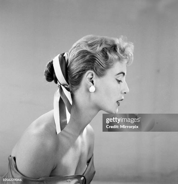 Cotton scarf and flower decorations for the hair, modelled by Pat O'Reilly. July 1955.