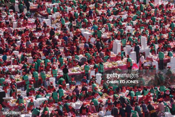 Volunteers take part in a kimchi making festival in Seoul on November 2, 2018. - The traditional Korean dish of spicy fermented cabbage and radish...