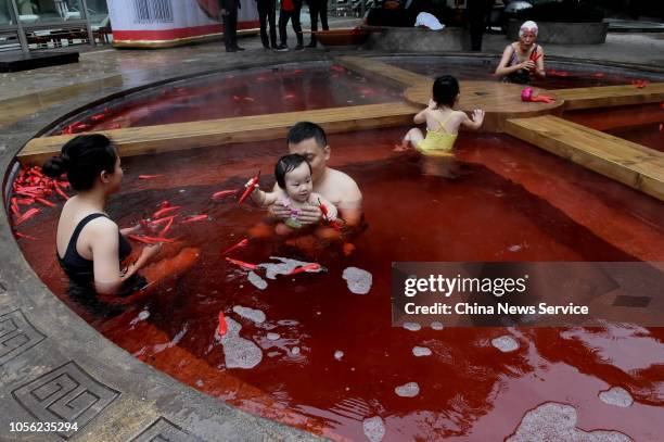 Citizens bath in a red hot spring in the shape of a giant hot pot at the Chongqing Ronghui Hot Spring Resort on October 18, 2018 in Chongqing, China....