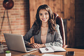 Cheerful attractive adorable stylish beautiful classic trendy business lady sitting in front of laptop at work place, station