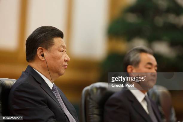 Chinese President Xi Jinping and Foreign Minister Wang Yi attend talks with Pakistani Prime Minister Imran Khan at the Great Hall of the People on...