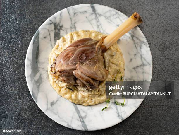 slow braised lamb shank with smoked eggplant puree - lamb shank stock pictures, royalty-free photos & images