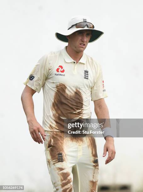 England bowler Olly Stone looks on with a muddy shirt after diving to field the ball during the Tour match between Sri Lanka Board President's XI and...