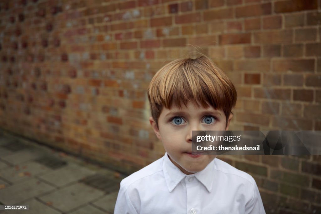 Portrait of wide eyed schoolboy