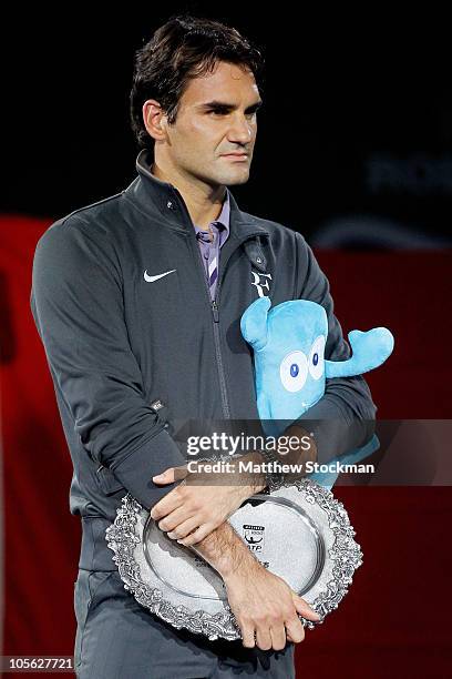 Roger Federer of Switzerland watches as Andy Murray of Great Britain is interviewed after the final on day seven of the 2010 Shanghai Rolex Masters...