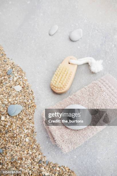 high angle view of massaging brush and towel for body care and beauty, tranquil scene - washcloth stockfoto's en -beelden