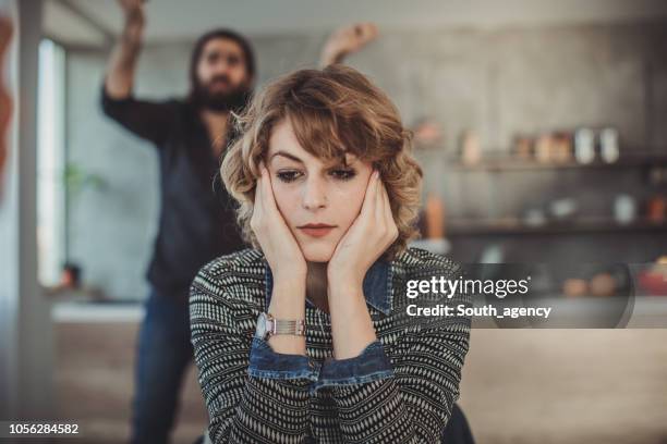 couple arguing about their problems at home - raiva emoção negativa imagens e fotografias de stock