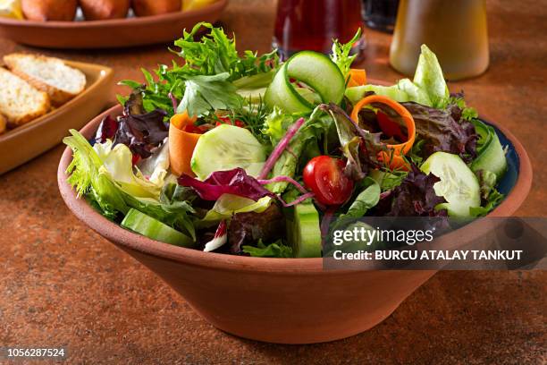 green salad with tomato and seasonal herbs - salad bowl stock pictures, royalty-free photos & images