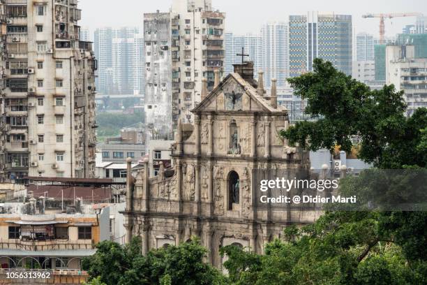 ruins of st paul church and apartment tower in macau - macao stock pictures, royalty-free photos & images