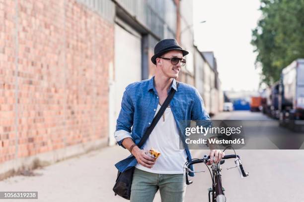 young man with bicycle on the street - fashion food stock pictures, royalty-free photos & images